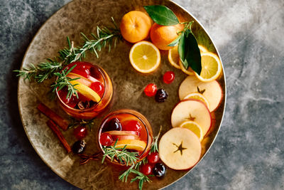 Mulled wine or christmas sangria with aromatic spices, apple, cherry and citrus fruits.