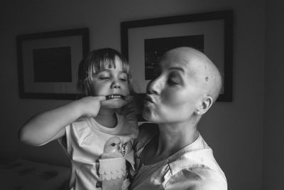 Mother and daughter making faces while at home