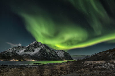 The green dragon hovering above mt. stornappstinden in flakstad island, lofoten archipelago