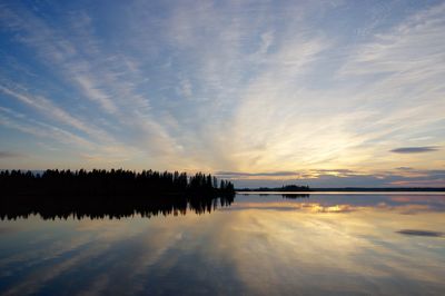 Reflection of clouds in lake at sunset
