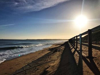 Scenic view of beach against sky during sunset