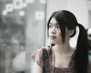 Close-up of young woman looking away