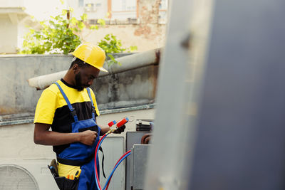 Side view of man working at construction site