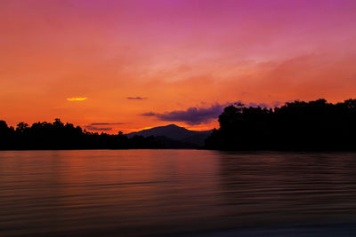 Scenic view of lake against romantic sky at sunset