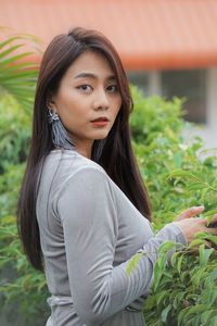 Portrait of a beautiful young woman standing outdoors