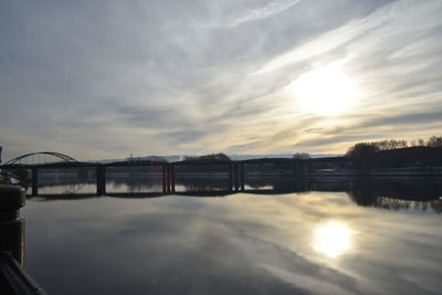 View of bridge over river against cloudy sky