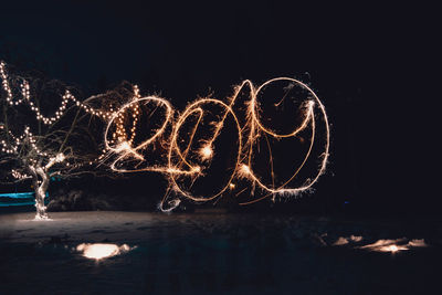 Illuminated light painting on water at night