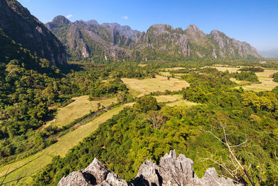 Scenic view of land and mountains against sky