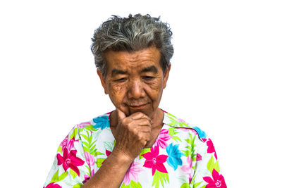 Portrait of man with arms raised against white background