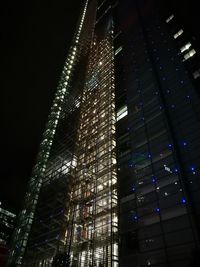 Low angle view of skyscrapers lit up at night