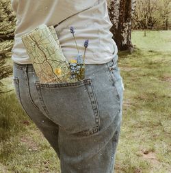 Midsection of woman standing on field