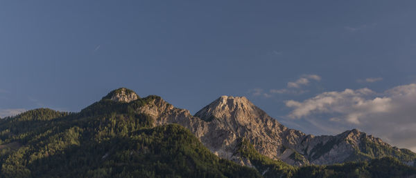 Scenic view of mountains against cloudy sky