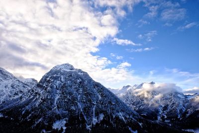 Scenic view of snow covered mountains against sky