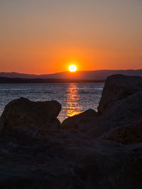 Scenic view of sea against romantic sky at sunset