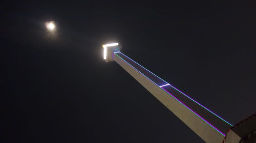 Low angle view of illuminated lights against clear sky at night