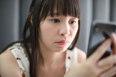 Close-up of woman using smart phone