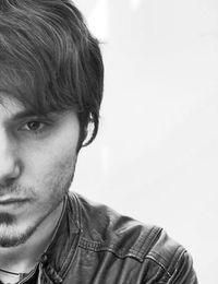 Close-up portrait of young man against white background