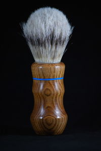 Close-up of paintbrushes against black background