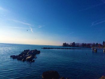 Scenic view of sea against blue sky