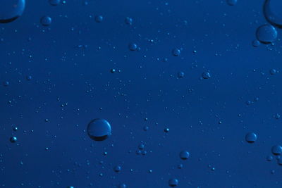 Full frame shot of raindrops on blue sky