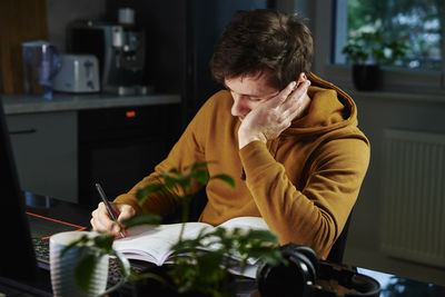 Tired man works late at workplace in the night