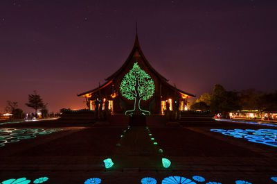 Illuminated bridge against sky at night