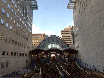 Railroad tracks amidst buildings in city