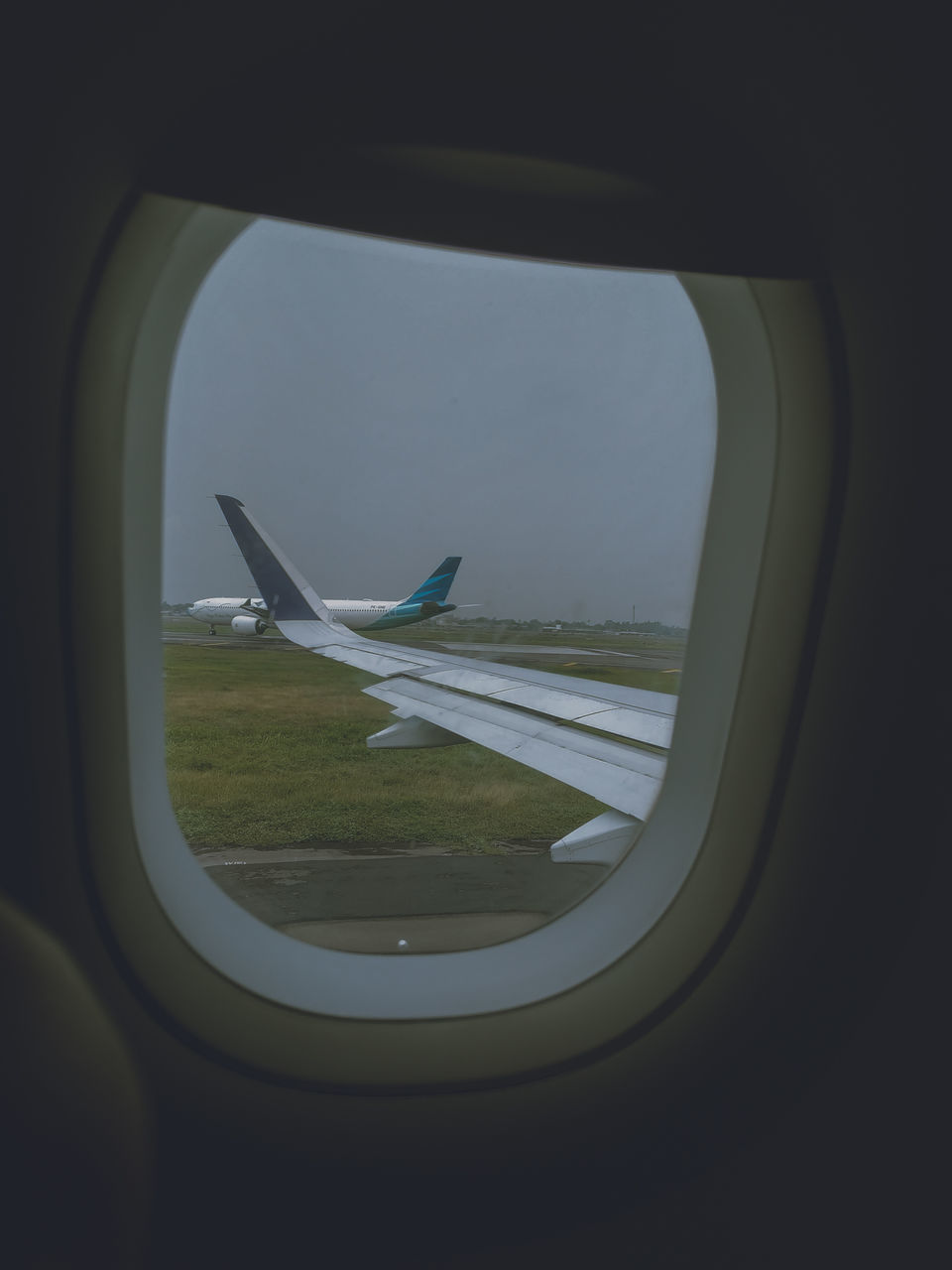 AIRPLANE FLYING SEEN THROUGH CAR WINDOW