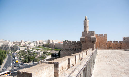 Buildings in city against clear sky