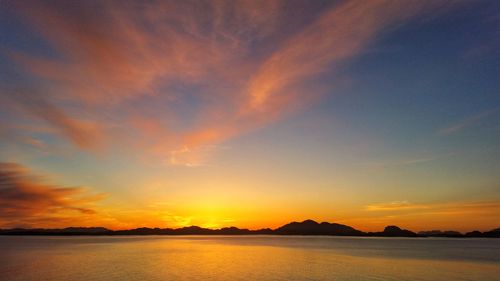 Scenic view of sea against romantic sky at sunset