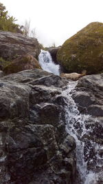 Scenic view of waterfall against clear sky