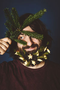 Bearded man holding christmas decoration