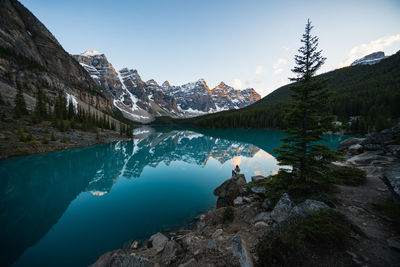 A hiker enjoying a canadian rockies sunset at moraine lake in banff