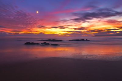 Scenic view of sea against sky at sunset