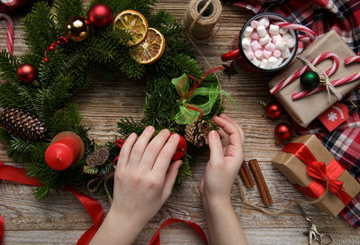 Cropped hands of woman holding christmas decoration