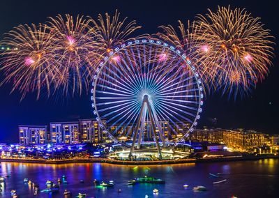 Low angle view of firework display at night