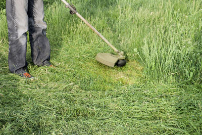 Low section of man working on grass