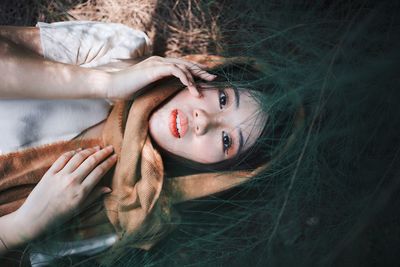 Portrait of woman lying on grass