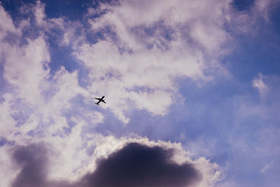 Low angle view of airplane flying in sky