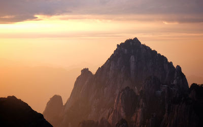 Rock formations against sky during sunset