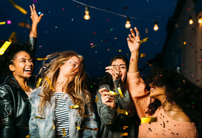 Young female friends enjoying party at night