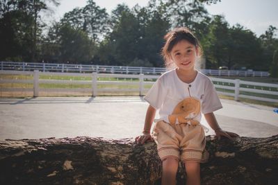 Portrait of happy girl holding camera