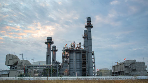 Low angle view of factory against sky