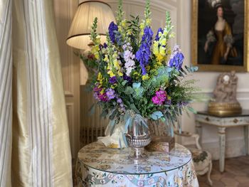 Close-up of flowers in glass vase on table