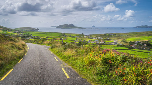 Scenic view of road by land against sky