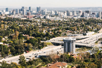 High angle view of trees and buildings in city