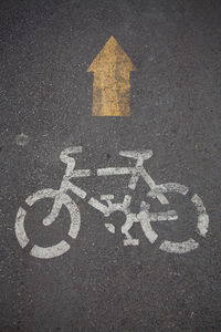 Directly above shot of bicycle lane sign on road