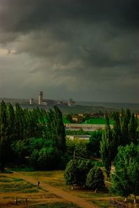 Scenic view of green landscape against cloudy sky