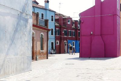 Footpath amidst buildings in city