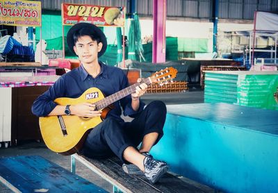 Portrait of man playing guitar